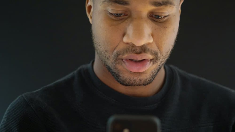 A business owner searching for his own company on a phone.